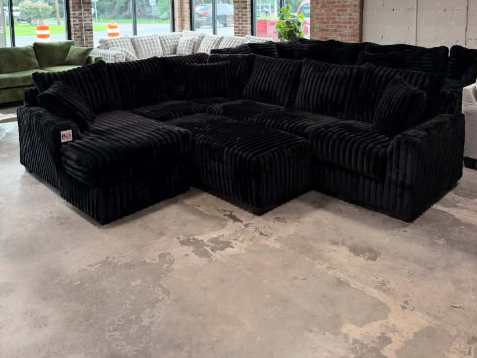 Black plush corduroy U-shaped sectional, showroom view 3