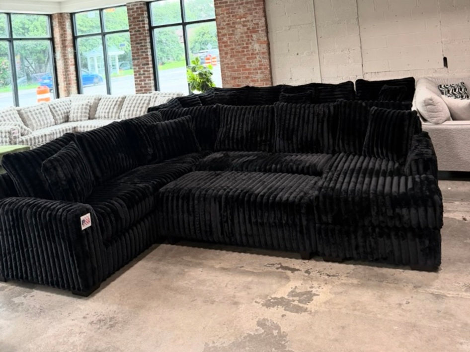 Black plush corduroy U-shaped sectional, showroom view 5