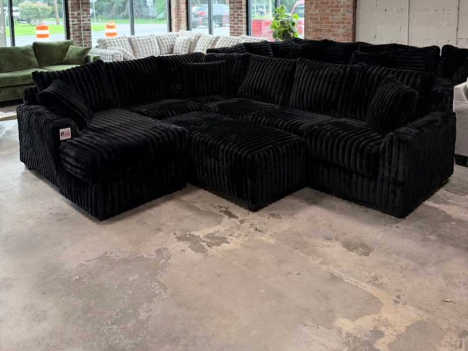 Black plush corduroy U-shaped sectional, showroom view 7