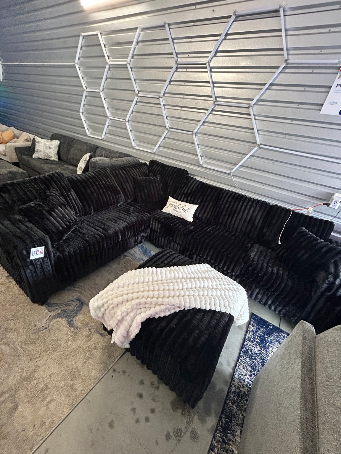 Black plush corduroy sectional with ottoman