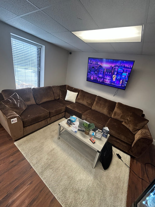 Luxe brown/copper velvet sectional — showroom view 1