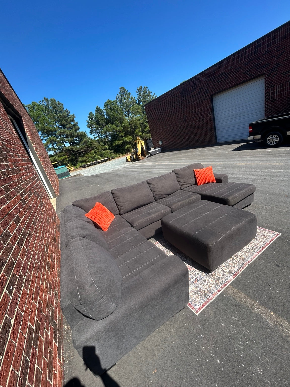 Used charcoal U-shaped sectional with chaise and matching ottoman shown