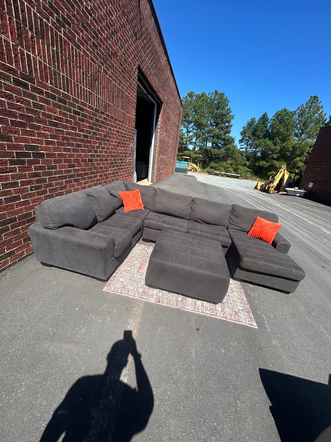 Used charcoal U-shaped sectional with chaise and matching ottoman shown