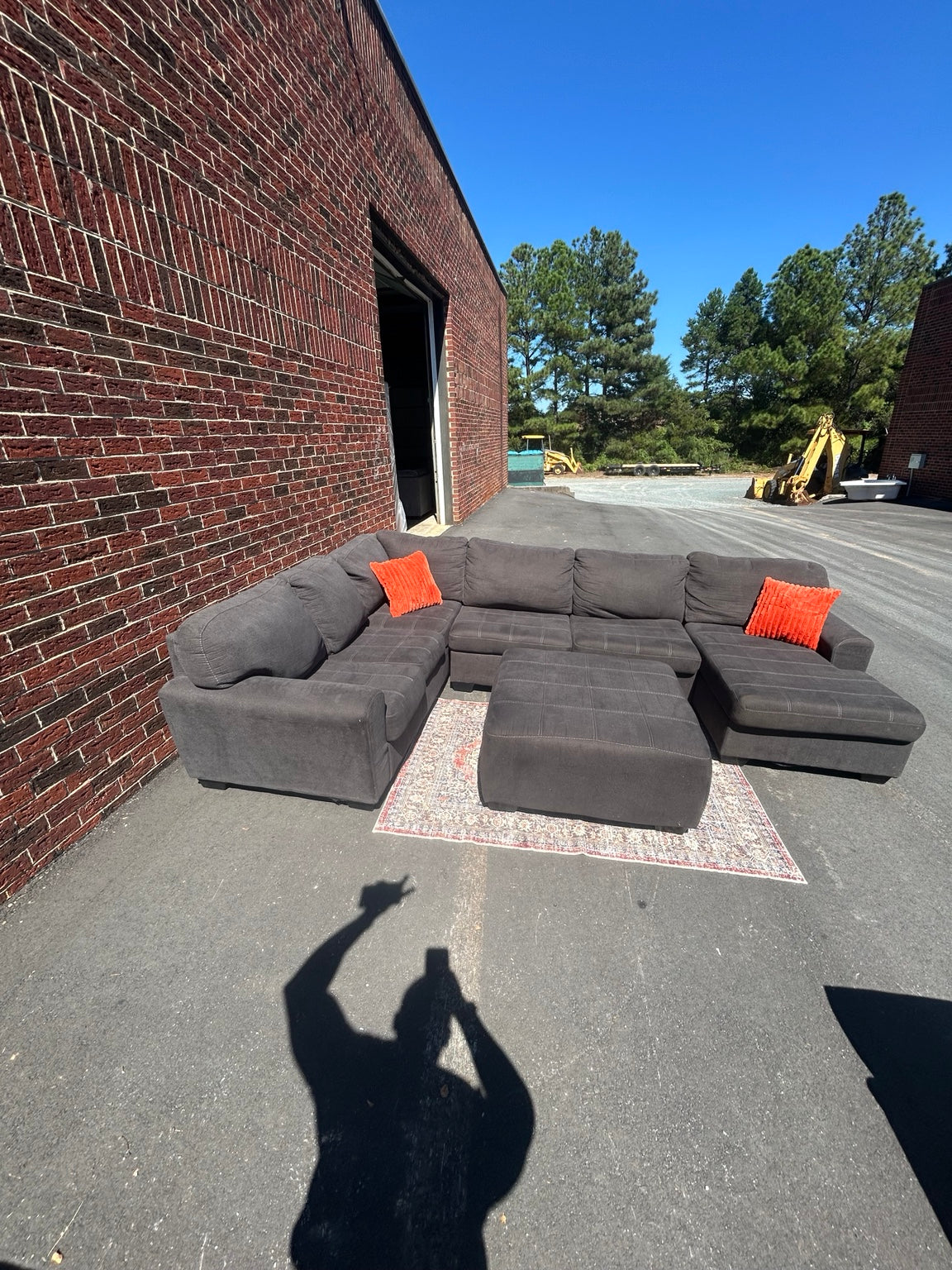 Used charcoal U-shaped sectional with chaise and matching ottoman shown