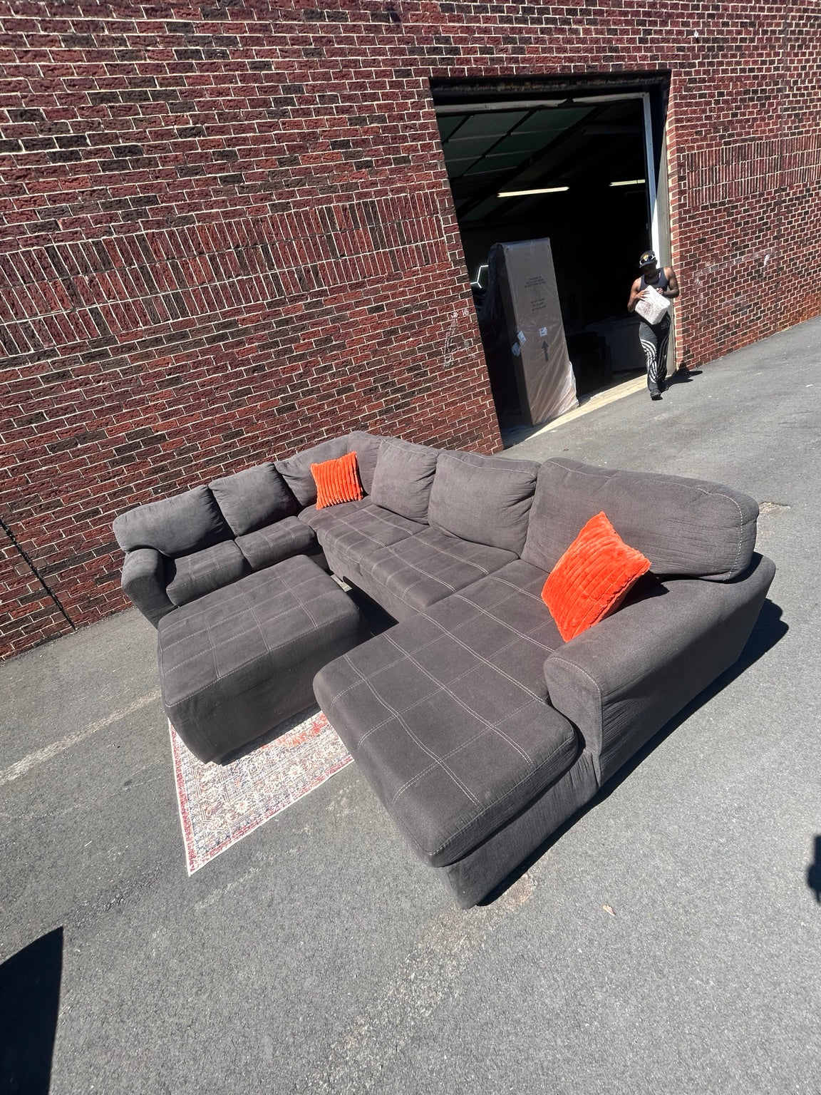Used charcoal U-shaped sectional with chaise and matching ottoman shown